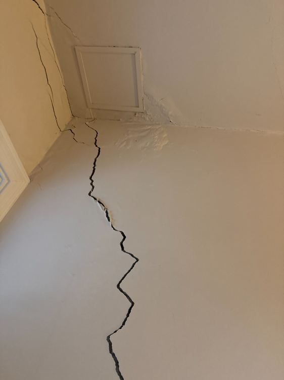 Prominent cracking to an internal wall and ceiling junction