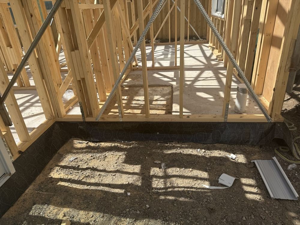 Wall framing, diagonal bracing and the slab edge at frame stage.